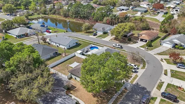 an aerial view of a house a yard and lake view