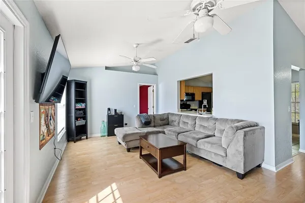 a living room with furniture and a chandelier