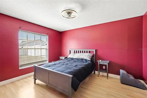 a bedroom with a bed and a window