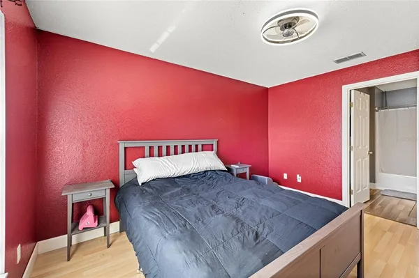 a bedroom with a bed and a dresser