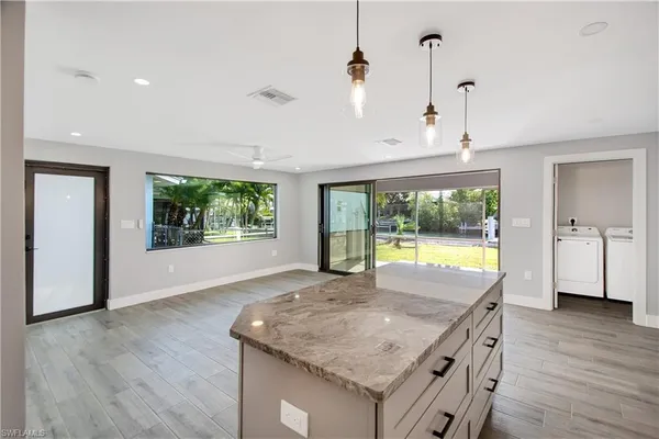 a view of a kitchen with a sink and wooden floor