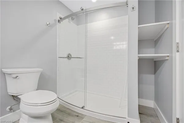 a bathroom with a shower and a toilet