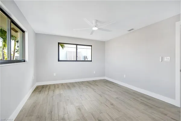 wooden floor in an empty room with a window
