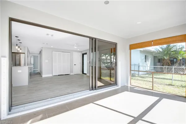 a living room with a large window and a rug