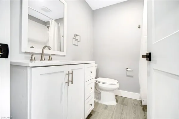 a bathroom with a sink toilet vanity and shower