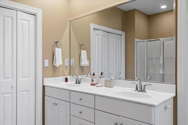 a bathroom with double vanity sinks and a mirror