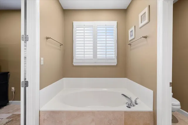 a white bath tub sitting next to a window