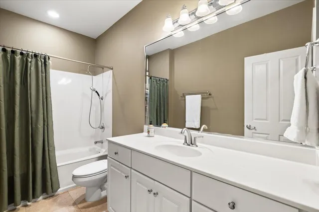 a bathroom with a sink a toilet and shower a mirror
