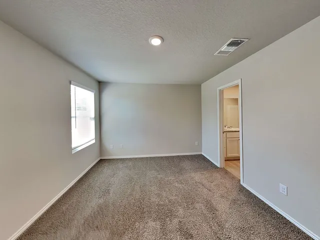 a bathroom with a granite countertop double vanity sink and mirror