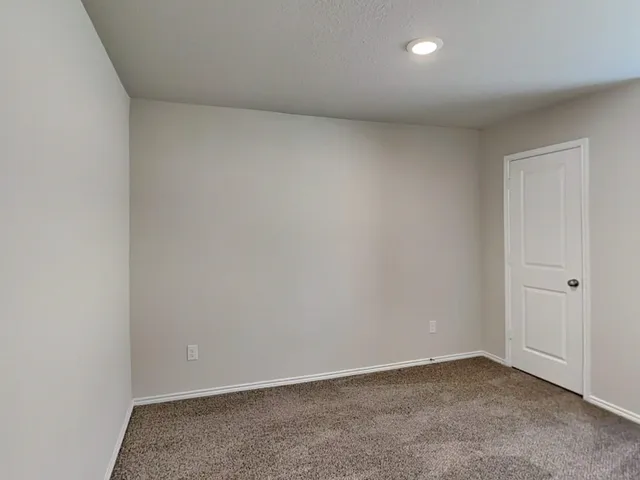 a bathroom with a granite countertop sink a toilet and a mirror
