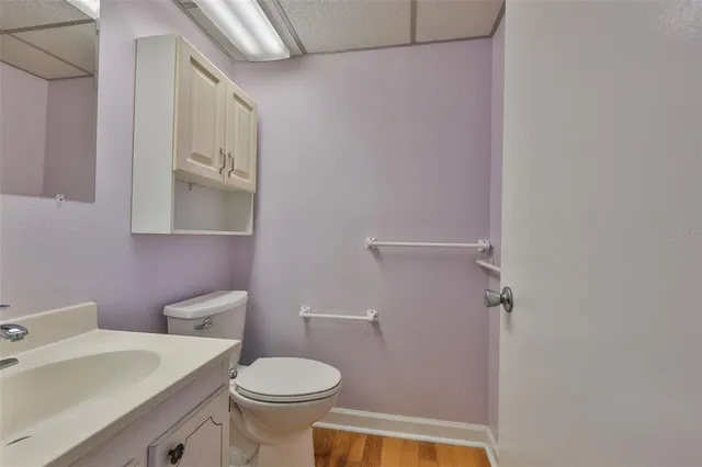 a white toilet sitting next to a bathroom sink