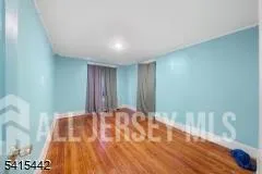 a view of staircase with wooden floor and white walls
