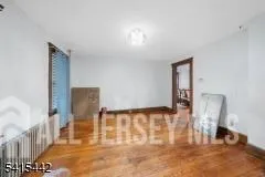 a view of a livingroom with furniture and wooden floor