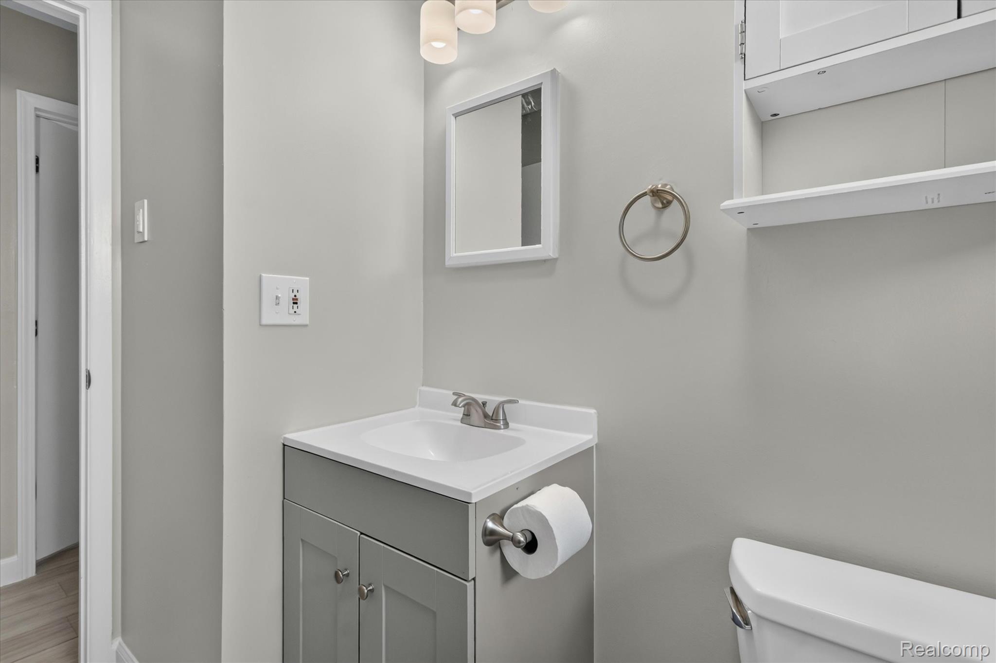 934 Harvard Road Berkley, MI 48072 - Photo 19 of 34 Bathroom featuring a gray vanity with a white countertop and integrated sink