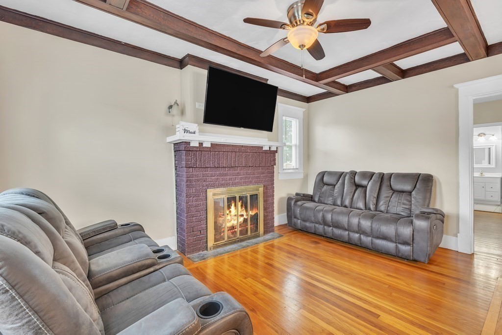 226 Jasper Street Springfield, MA 01109 - Photo 6 of 27 a living room with furniture a flat screen tv and a fireplace