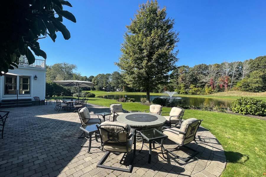 310 Willowbend Drive Mashpee, MA 02649 - Photo 11 of 37 a view of a patio with table and chairs a fire pit and a yard