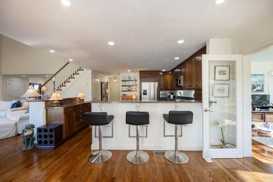 310 Willowbend Drive Mashpee, MA 02649 - Photo 18 of 37 a kitchen with stainless steel appliances kitchen island granite countertop a table and chairs in it