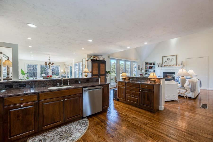 310 Willowbend Drive Mashpee, MA 02649 - Photo 19 of 37 a kitchen with stainless steel appliances granite countertop a sink and wooden cabinets