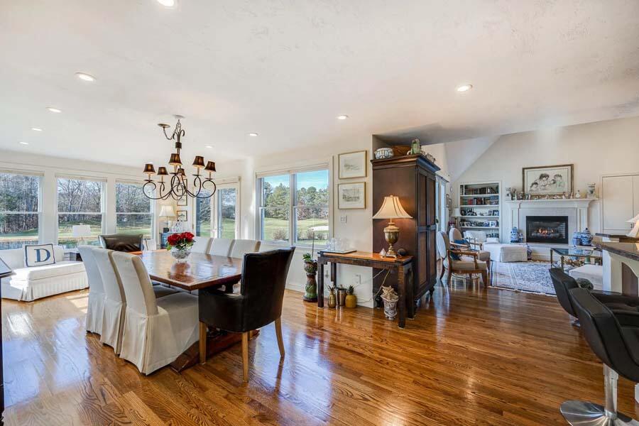 310 Willowbend Drive Mashpee, MA 02649 - Photo 21 of 37 a dining room with wooden floor a chandelier a glass table and chairs
