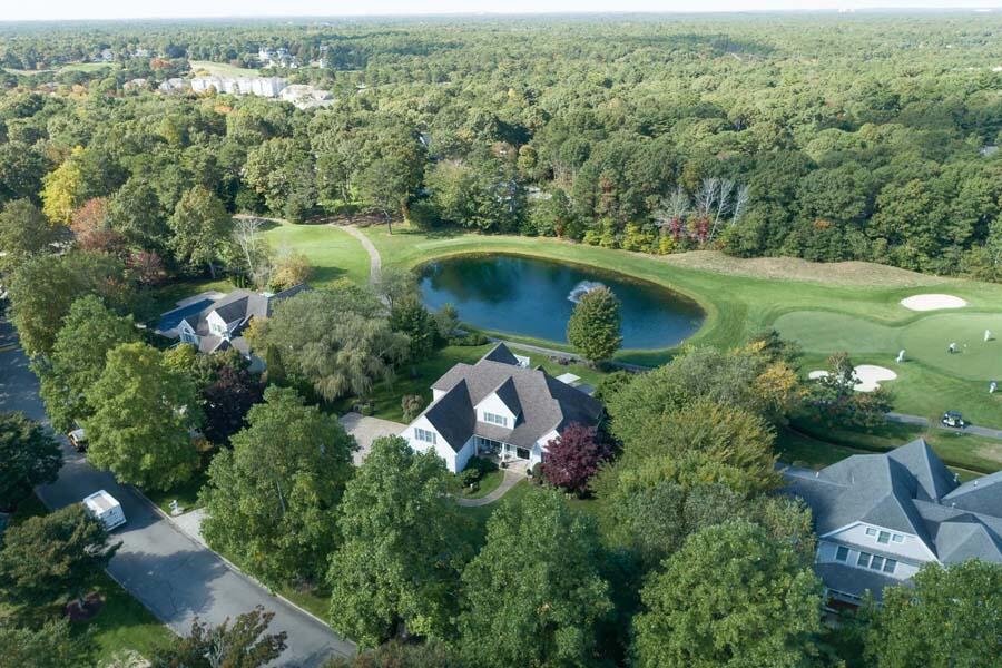 310 Willowbend Drive Mashpee, MA 02649 - Photo 4 of 37 an aerial view of a house with a garden and lake view