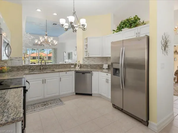 a kitchen with a refrigerator and a sink