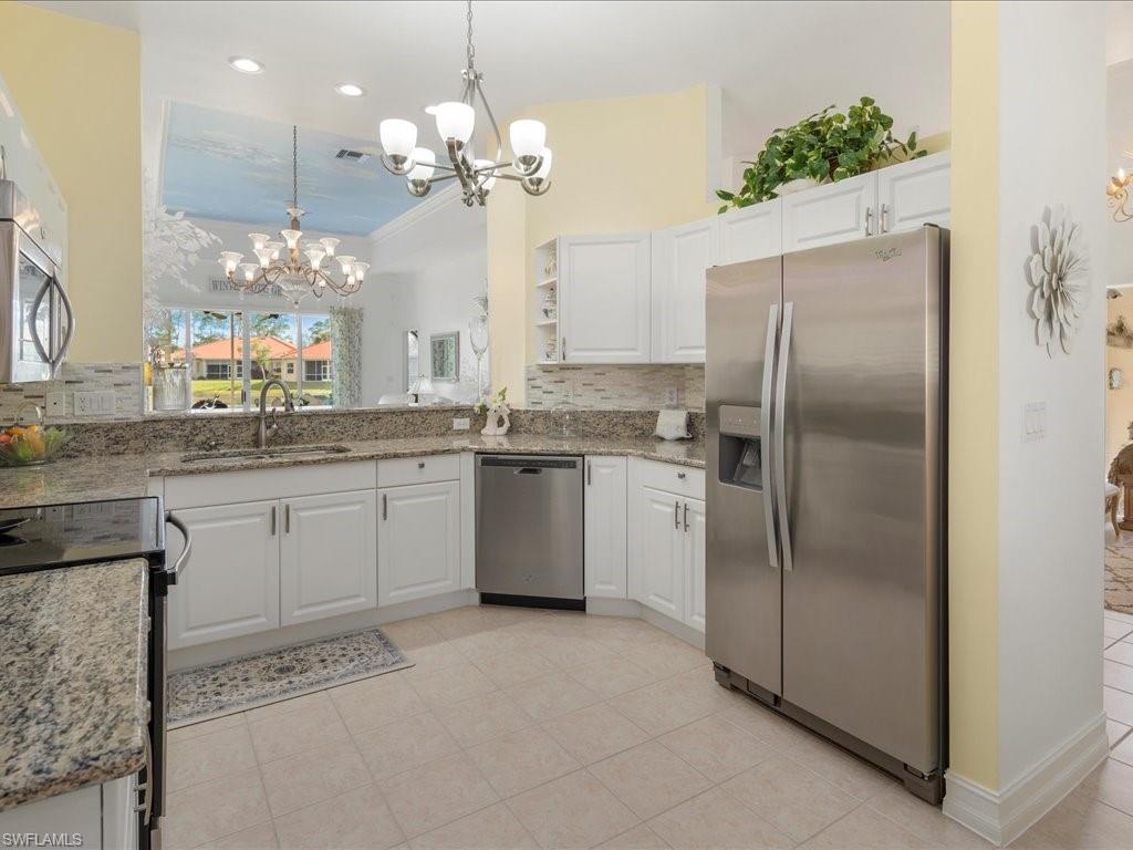 7918 Haven Drive, Unit 2 Naples, FL 34104 - Photo 14 of 30 a kitchen with a refrigerator and a sink