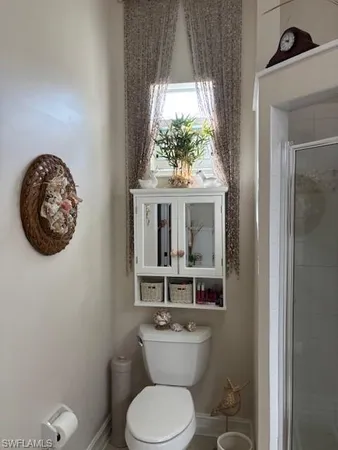 a bathroom with a toilet a sink and a large mirror