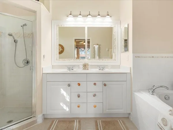a bathroom with a shower sink and mirror
