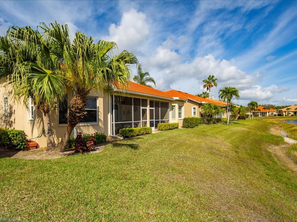 7918 Haven Drive, Unit 2 Naples, FL 34104 - Photo 29 of 30 a front view of a house with garden