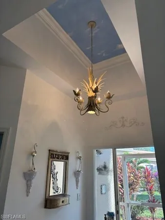a picture of a room with a mirror and a chandelier fan