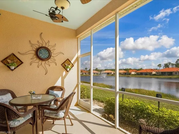 a view of a balcony dining area and a lake view