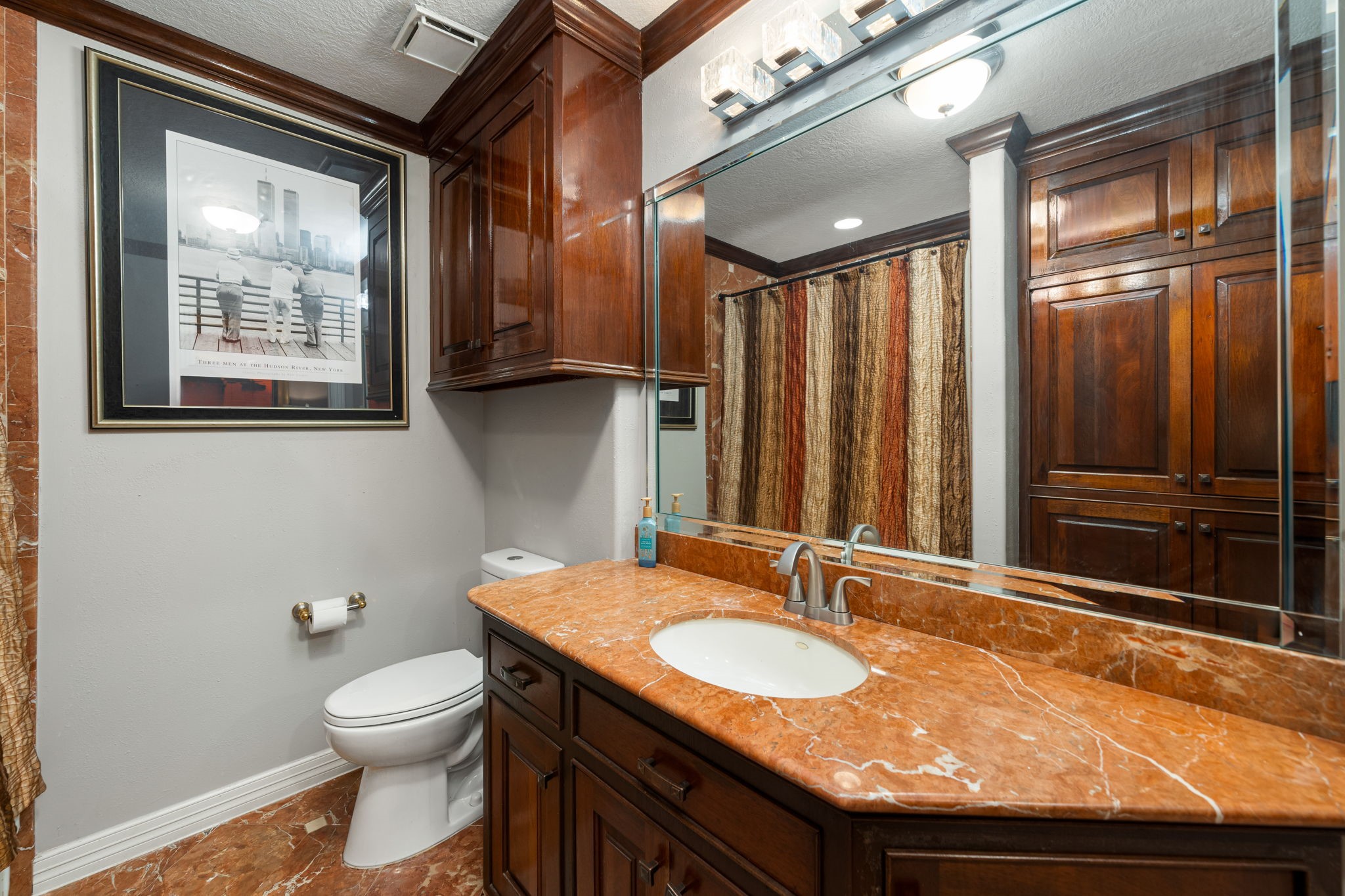 3519 Singleton Road Baytown, TX 77521 - Photo 35 of 46 a bathroom with a granite countertop sink a toilet a mirror and shower
