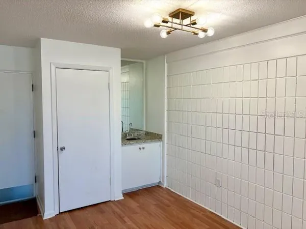 a view of a room with wooden floor
