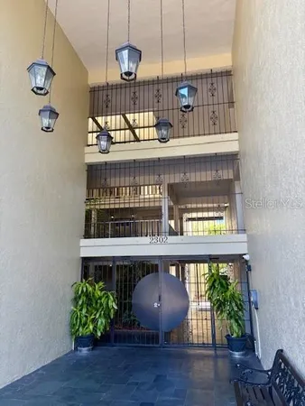 a view of a room with wooden floor and windows
