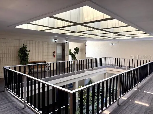 a view of staircase with railing and white walls