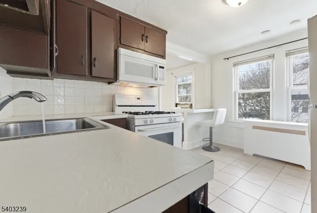 a kitchen with stainless steel appliances granite countertop a stove a refrigerator and a refrigerator