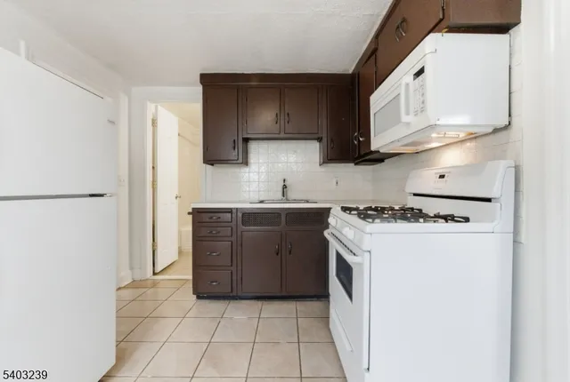 a view of a bedroom with a window and furniture