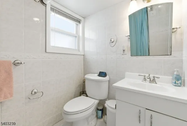 a view of staircase with railing and white walls