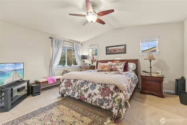 a bedroom with a large bed and a window