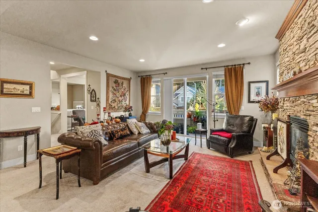 a living room with furniture fireplace and a window