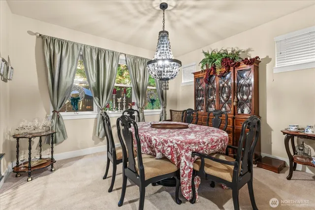a view of a dining room with furniture and a chandelier