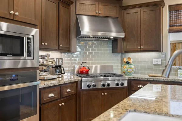 a kitchen with a stove a sink and a cabinets