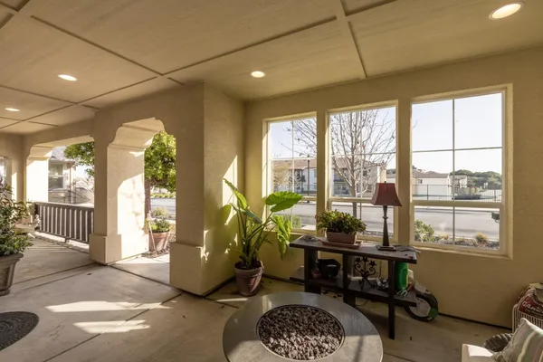 a living room with furniture and a floor to ceiling window