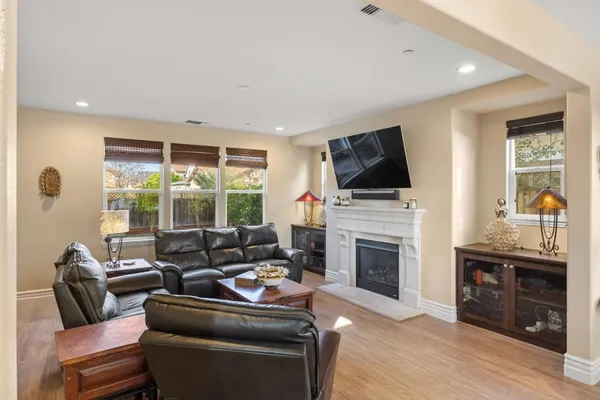 a living room with furniture a fireplace and a flat screen tv