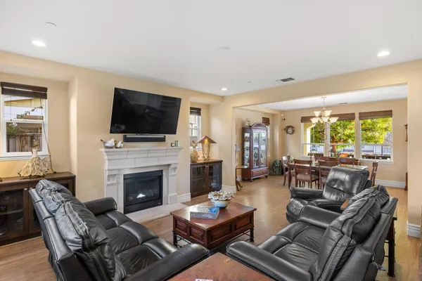 a living room with furniture fireplace and flat screen tv