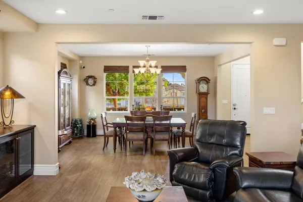 a living room with furniture couches and a large window