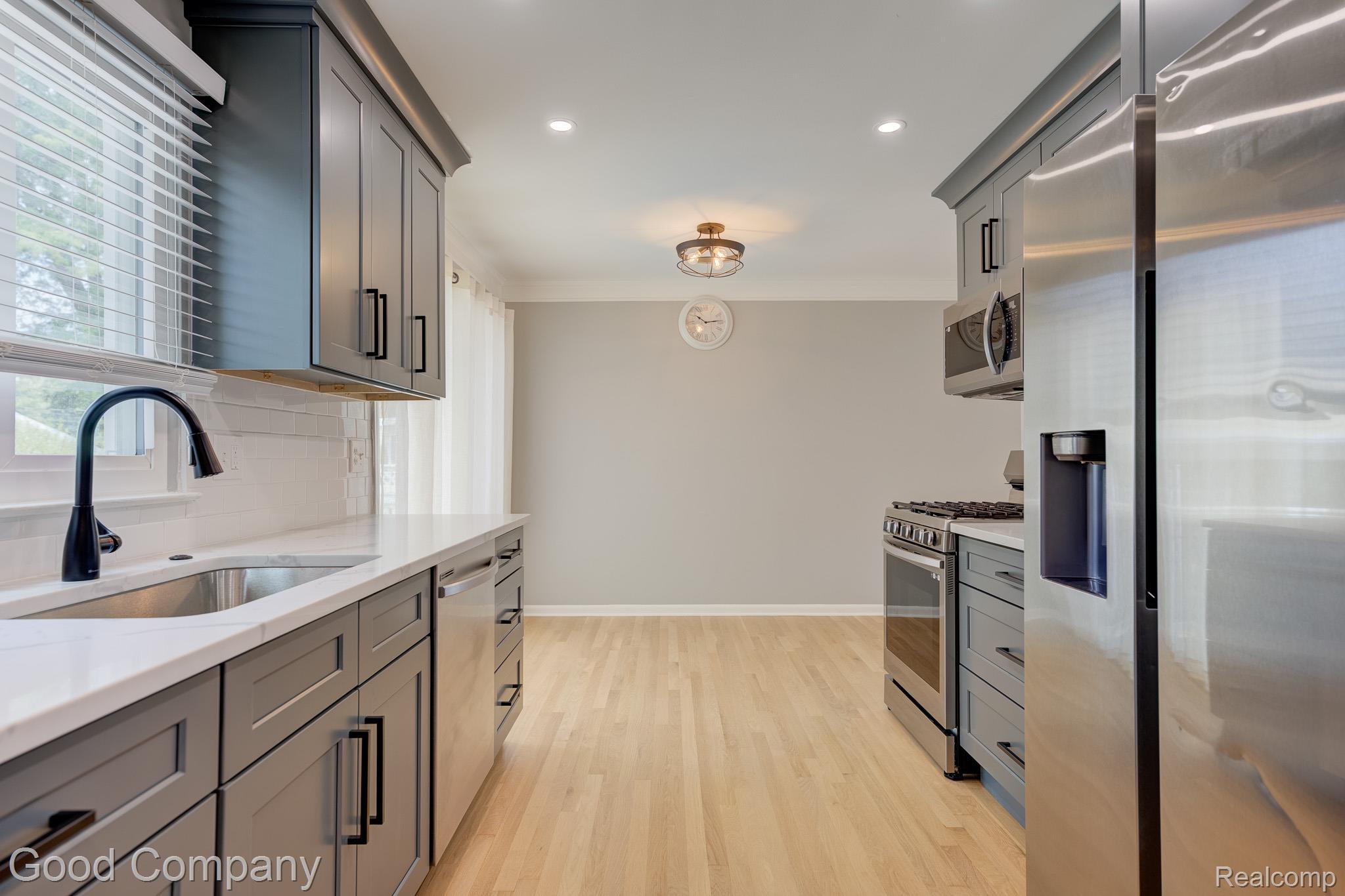 1842 Massoit Road Royal Oak, MI 48073 - Photo 16 of 52 Light wood-finish flooring with recessed lighting, gray shaker-style cabinetry, and stainless steel appliances