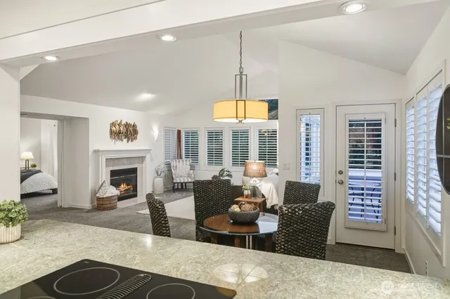a living room with fireplace furniture and a large window