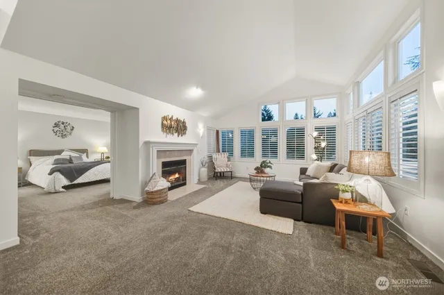a living room with furniture large window and a fireplace