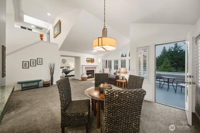 a living room with fireplace furniture and a large window